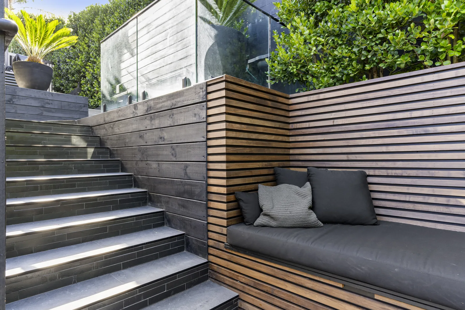 Tiled outdoor patio with slip-resistant porcelain tiles at an Auckland home by Tarara Tiling