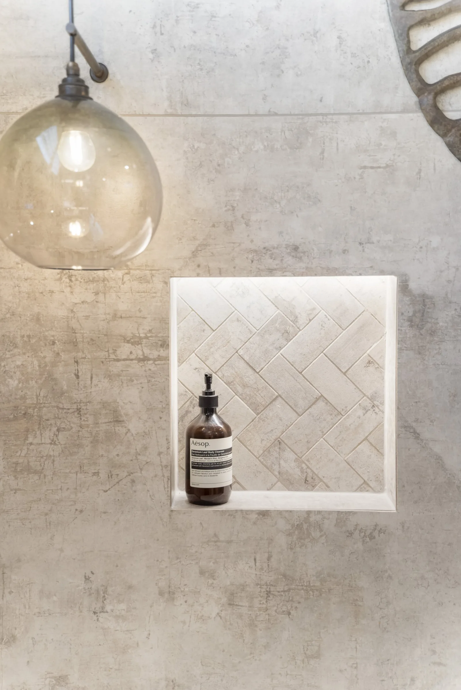 Detailed herringbone marble niche — feature tiling in an Auckland home by Tarara Tiling