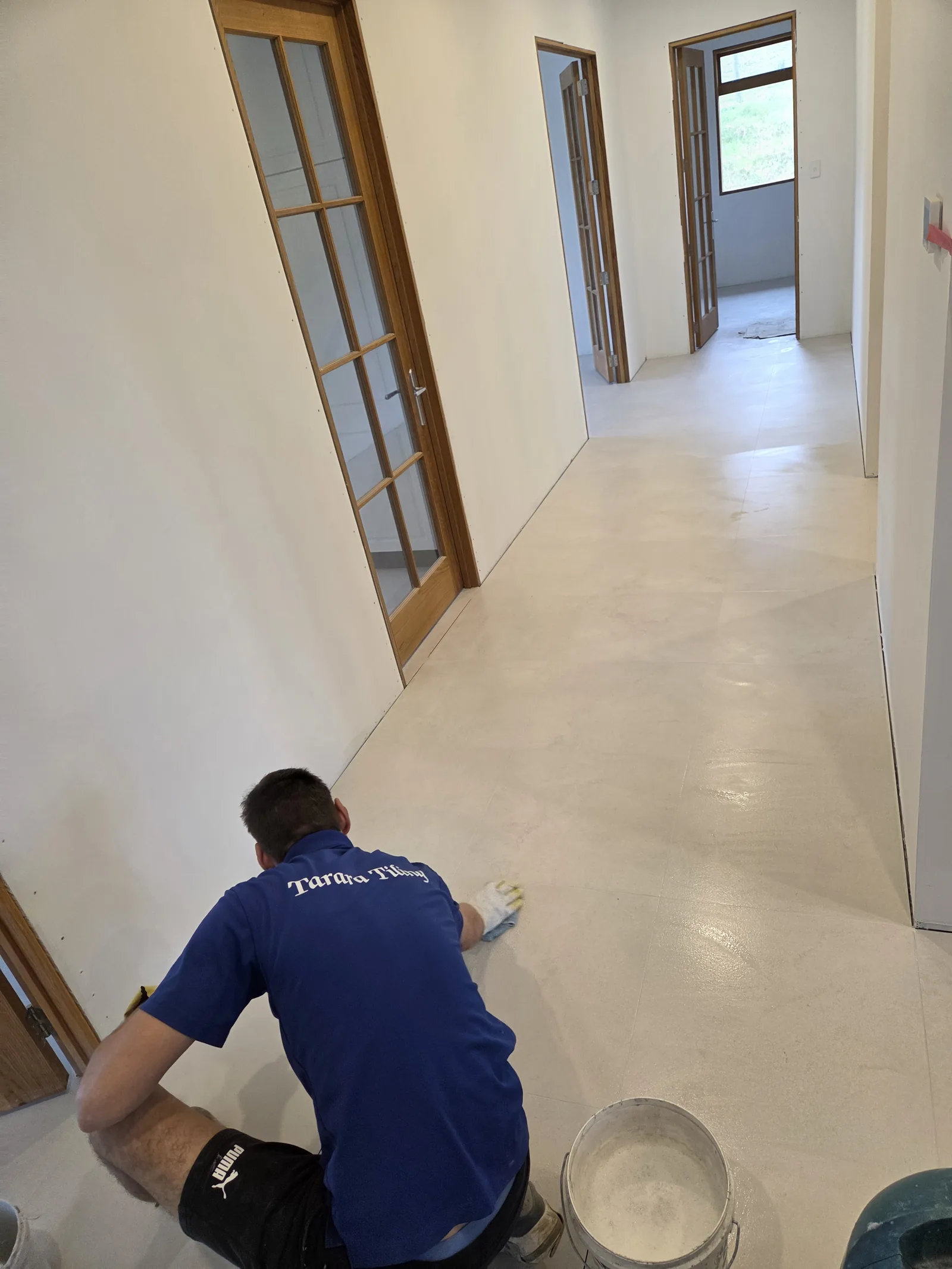 Croatian master tiler Marko setting large-format tiles on an Auckland project