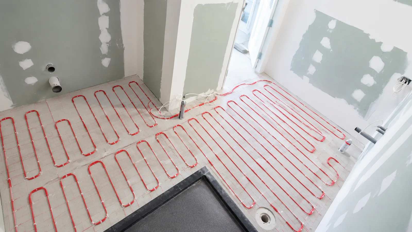 Electric underfloor heating mat installed before tiling a bathroom floor in Auckland by Tarara Tiling