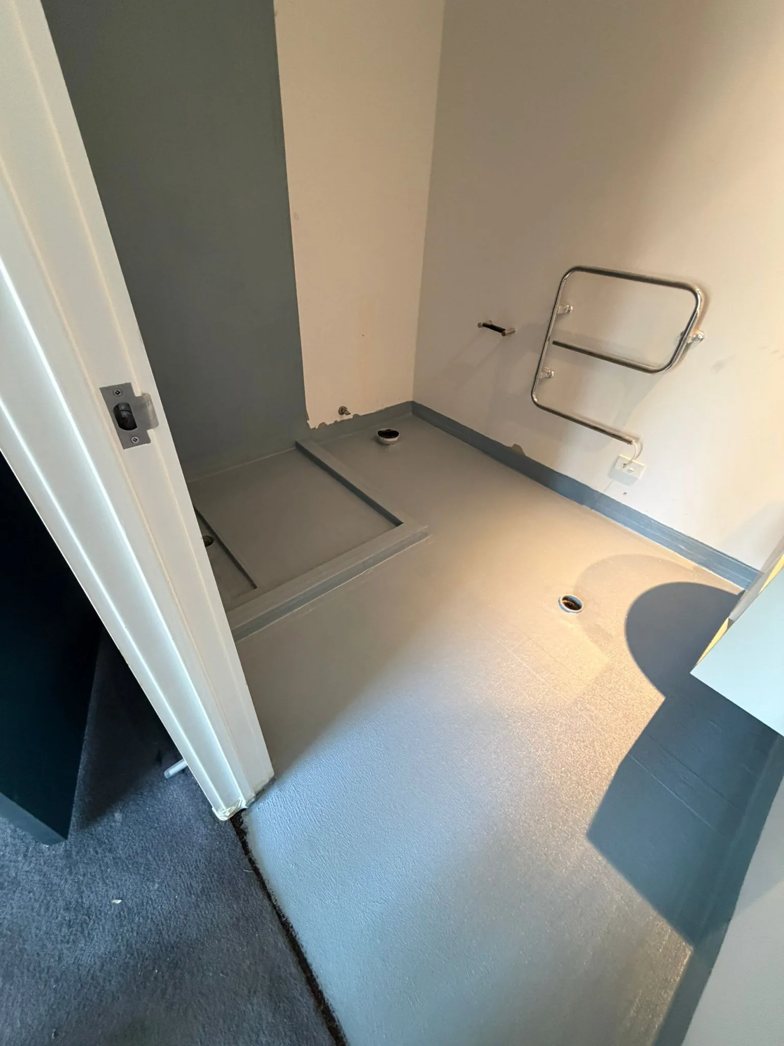 Waterproofing membrane being applied to a shower base in an Auckland bathroom